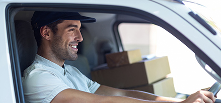 happy-man-in-car-with-boxes