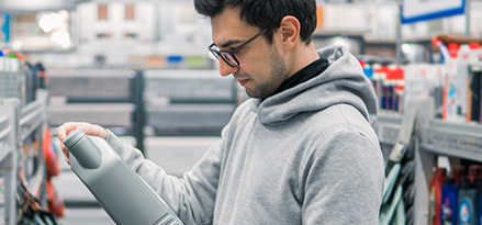 Man in Gray Hoodie Choosing Oil