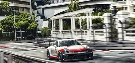 porsche-driving-down-street